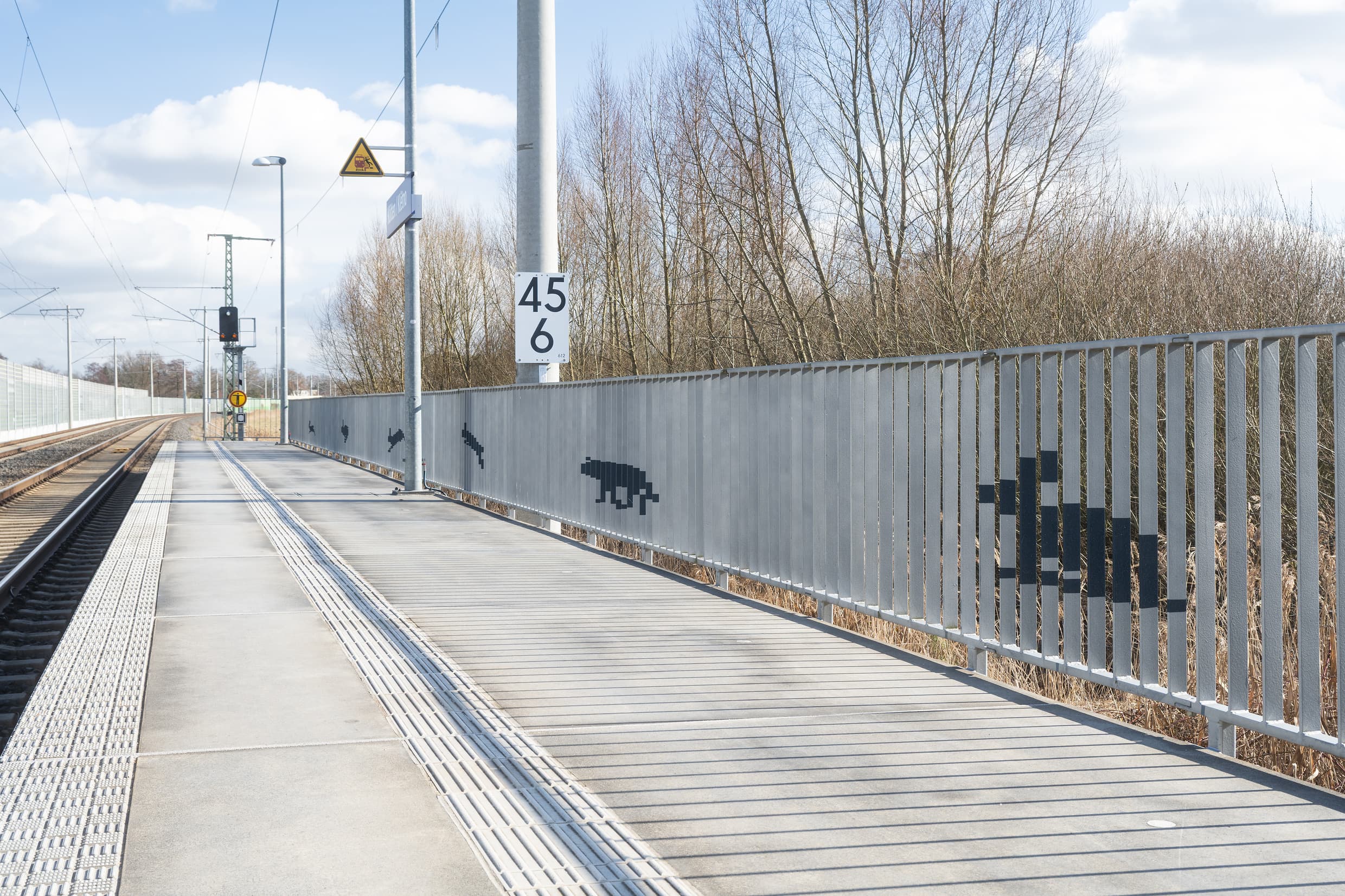 Detailfoto vom gestalteten Geländer mit Hase und Wolf.