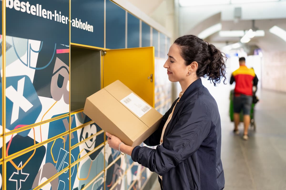 A woman takes a parcel from the collection point.