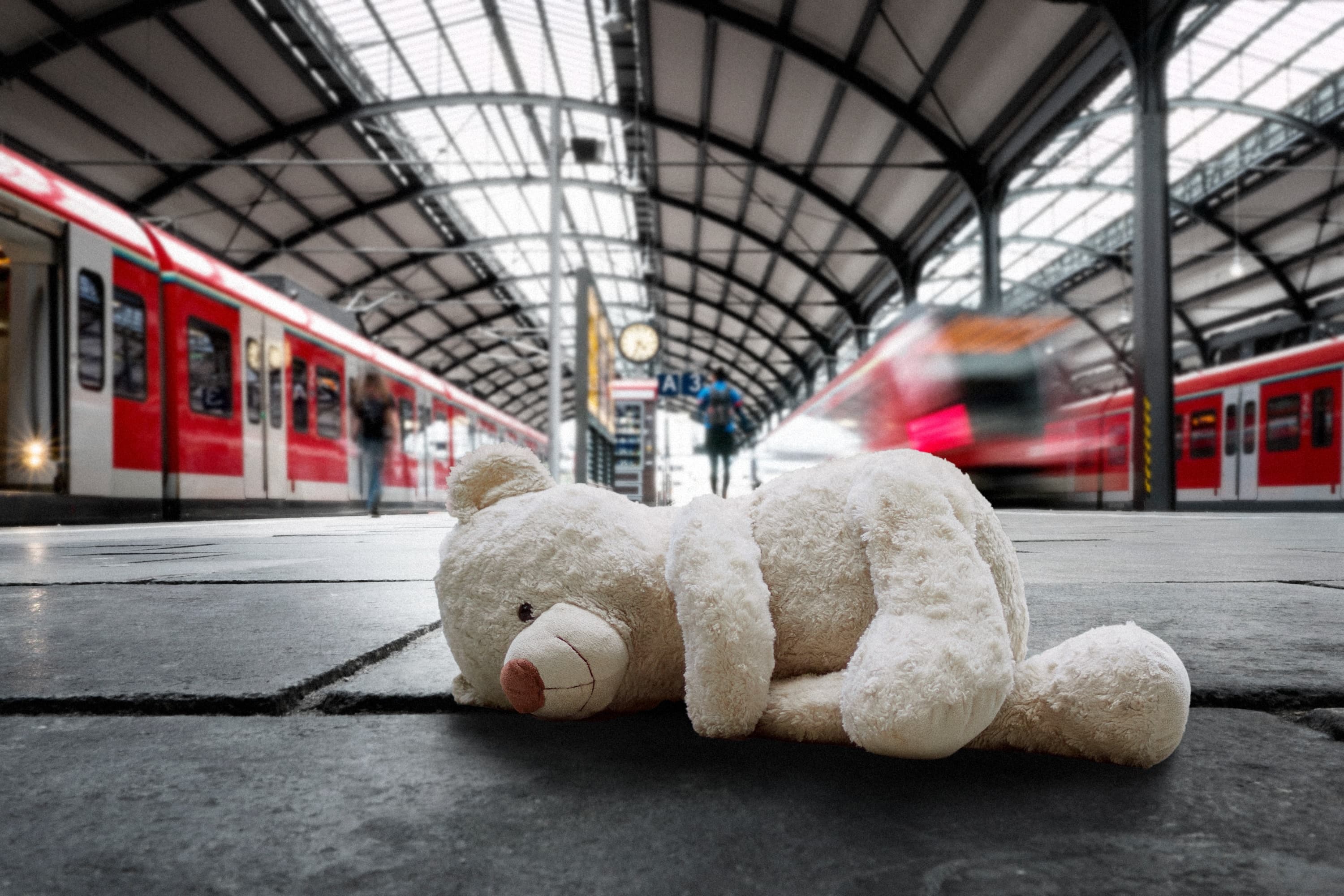 A lost cuddly toy on the floor of the platform.