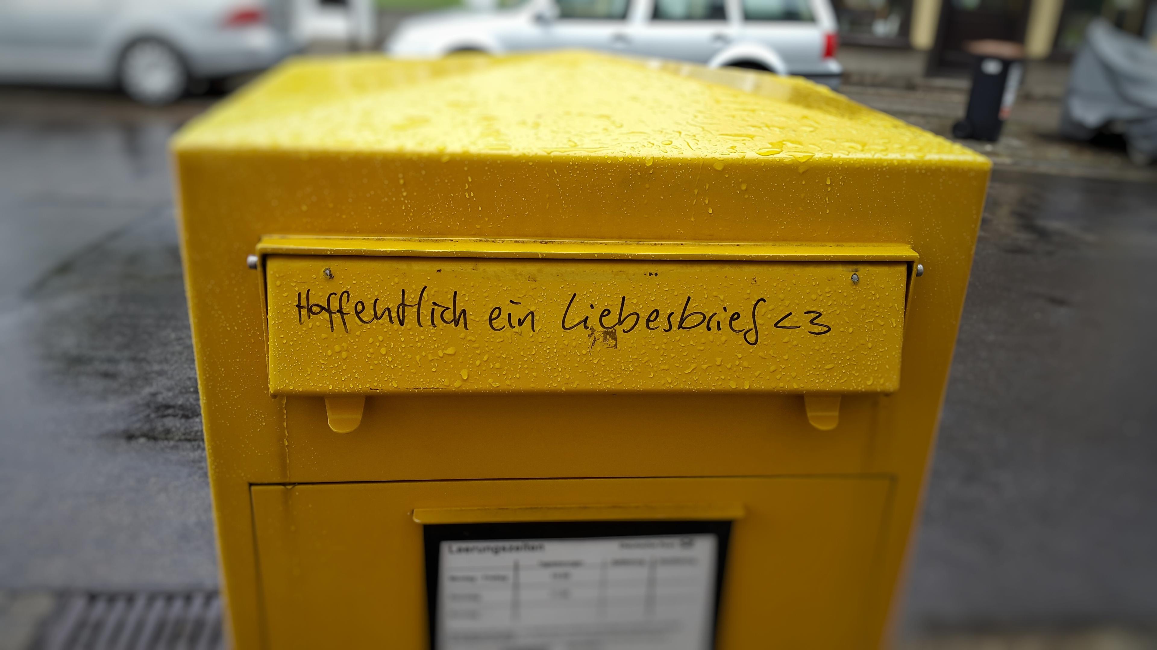 A yellow letterbox from the post office.